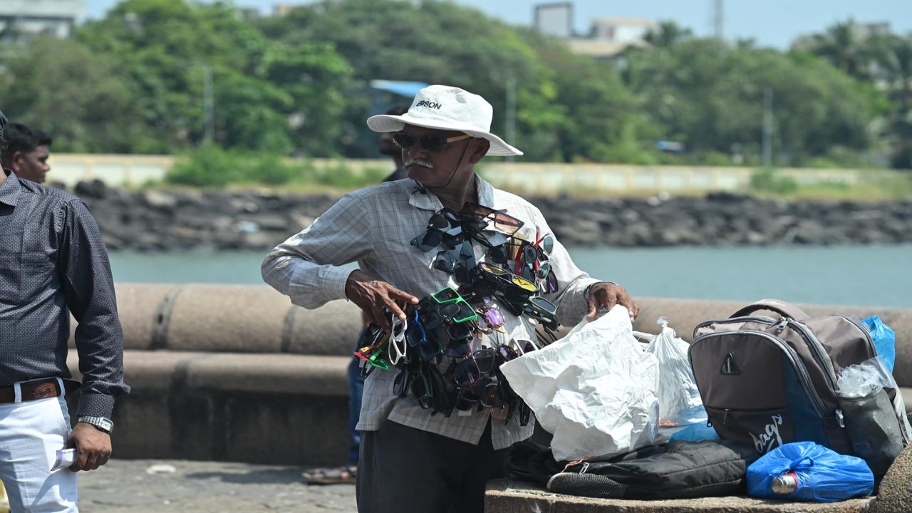 A man sells sunglasses at Gateway of India