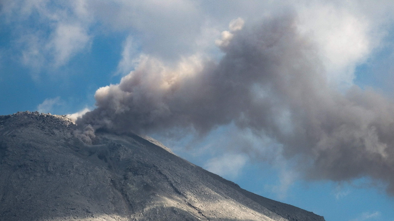 Mount Lewotobi spews volcanic ash from its crater during an eruption as seen from Duripali village in East Flores, Indonesia's East Nusa Tenggara province on October 12