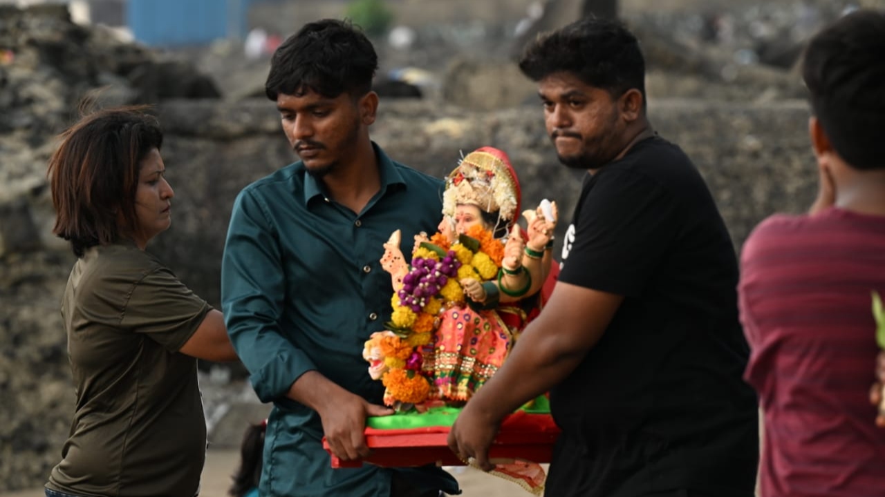 As the idols were submerged in water, emotions ran high, with some devotees 